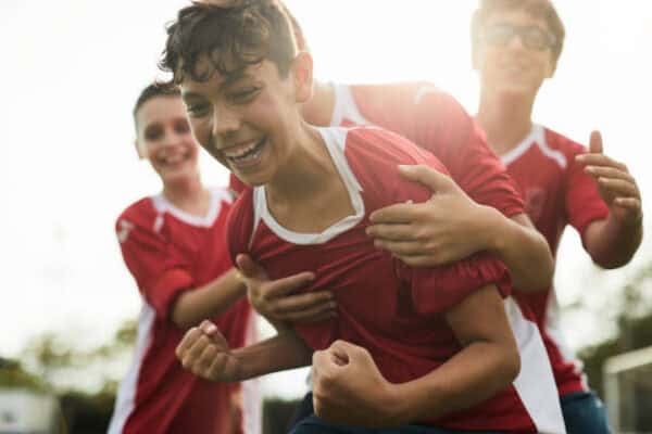 A happy kid celebrating in a football match